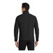 A man wearing a black Port Authority Core Soft Shell Jacket with a zipper pocket.
