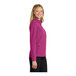A woman wearing a Port Authority Very Berry soft shell jacket.