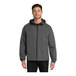 A man wearing a graphite Port Authority Essential Rain Jacket.