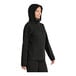 A woman wearing a black Port Authority rain jacket with a hood.