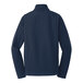 A back view of a Port Authority dress blue soft shell jacket with long sleeves.