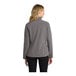 A woman wearing a Port Authority women's deep smoke soft shell jacket.