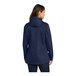 A woman wearing a Port Authority navy parka jacket.