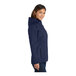 A close-up of a Port Authority women's navy parka jacket with a hood and zipper.