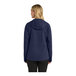 A woman wearing a navy Port Authority rain jacket.