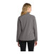 A woman wearing a grey Port Authority Core Soft Shell Jacket.