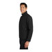 A man wearing a black Port Authority core soft shell jacket.