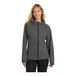 A woman wearing a graphite Port Authority rain jacket.