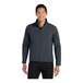 A man wearing a Port Authority Core Soft Shell Jacket in Battleship Gray.
