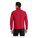 A man wearing a red Port Authority Core Soft Shell Jacket.