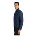 A man wearing a Port Authority dress blue core soft shell jacket.