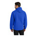 A man wearing a Port Authority true royal blue rain jacket with a hood.