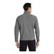 A man wearing a Port Authority Core Soft Shell Jacket in pearl gray heather.