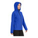 A woman wearing a Port Authority True Royal Essential Rain Jacket in blue.
