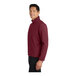 A man wearing a Port Authority maroon soft shell jacket.