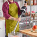 A man using a Vitamix Immersion Blender in a professional kitchen.