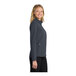 A woman wearing a Port Authority Core Soft Shell Jacket in battleship gray.