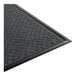 A black 4' x 6' customizable anti-fatigue entrance mat with a textured surface and beveled edges.