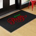 A black entrance mat with red and green lettering that reads 'Italian Pizza,' designed for indoor or outdoor use.