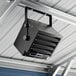 A black Boltic electric ceiling-mounted garage or unit heater installed on a metal ceiling.