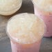 A group of pink drinks with Bossen Lychee Jelly toppings and white food in them.