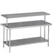 An Advance Tabco stainless steel middle mount shelf on a work table.