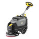 A cordless walk-behind floor scrubber with a handle, two large wheels, and a compact design.