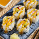 A plate of sushi rolls with Nippon Shokken Mango Sauce.