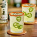 Two glasses of Master of Mixes Jalapeno Syrup margaritas on a table.