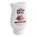 A white plastic bottle of Real Fig Puree Infused Syrup with a label.