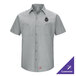 A gray short sleeve men's work shirt with two chest pockets and a customizable logo on the left chest.
