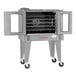 A commercial stainless steel electric convection oven with five shelves, double glass doors, and caster wheels.