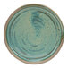 A close-up of a Cosy & Trendy Ocean Green stoneware saucer with a brown rim.