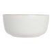A beige stoneware bowl with a gold rim.