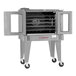 A commercial stainless steel convection oven with five shelves, open double doors, and casters for mobility.
