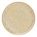 A close up of a Cosy & Trendy beige stoneware coupe plate with speckles.