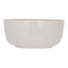 A white stoneware bowl with a gold rim.