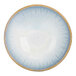 A white porcelain bowl with blue stripes and a black spot in the center.
