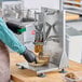 A person using a Garde countertop potato wedge cutter to make potato wedges.