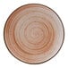 A close-up of a Cosy & Trendy terracotta stoneware coupe plate with a spiral design.