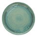 A close up of a Cosy & Trendy Ocean Green stoneware plate with a circular design.