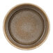 A close-up of a green porcelain Cosy & Trendy bowl with a brown rim.