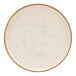 A white Cosy & Trendy stoneware coupe plate with black dots.