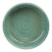 A close-up of a green Cosy & Trendy Basalt stoneware plate with a speckled design.