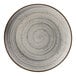 A close-up of a Cosy & Trendy Sintra dusty blue stoneware coupe plate with a spiral design in white and gray.