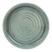 A close-up of a Cosy & Trendy Ocean Green stoneware plate with a swirled design in blue and white.