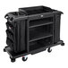 A black Rubbermaid housekeeping cart with black bags on it.