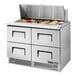 A True Mega Top Refrigerated Sandwich Prep Table with food trays on the counter.
