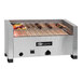 An EmberGlo natural gas countertop kabob charbroiler with meat and vegetables cooking on it.