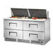 A True refrigerated sandwich prep table with food trays on top.